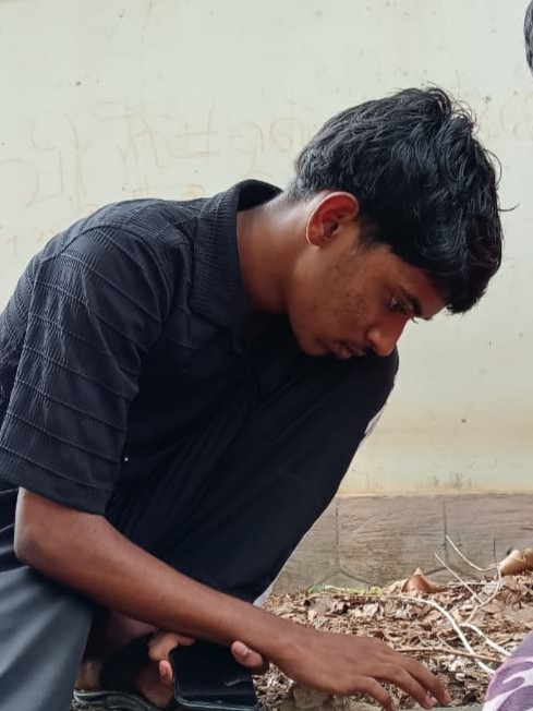 Ajay squatting on ground